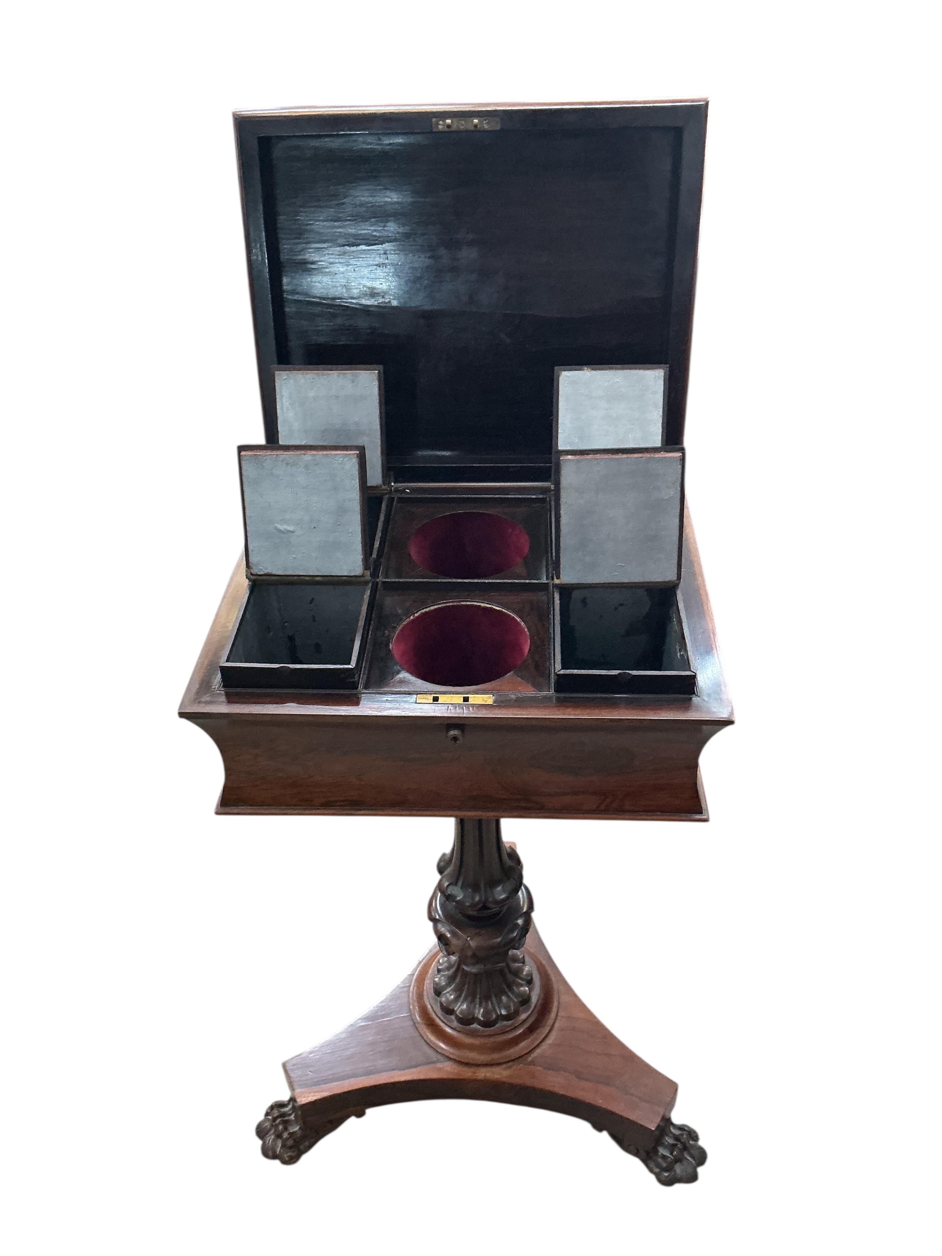 An early Victorian rosewood teapoy, on triangular platform and lion's paw feet, width 40cm, depth 33cm, height 78cm